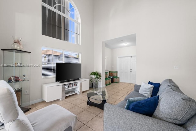 15490 SW 18th Ln, Miami, FL 33185 - living area with a towering ceiling, light tile patterned floors, and baseboards