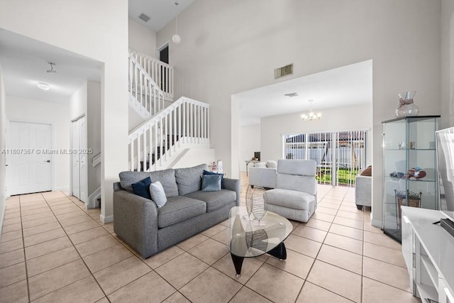15490 SW 18th Ln, Miami, FL 33185 - living room with a high ceiling, light tile patterned floors, a chandelier, and stairs