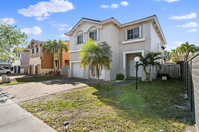 15490 SW 18th Ln, Miami, FL 33185 - view of front facade featuring an attached garage, decorative driveway, and stucco siding