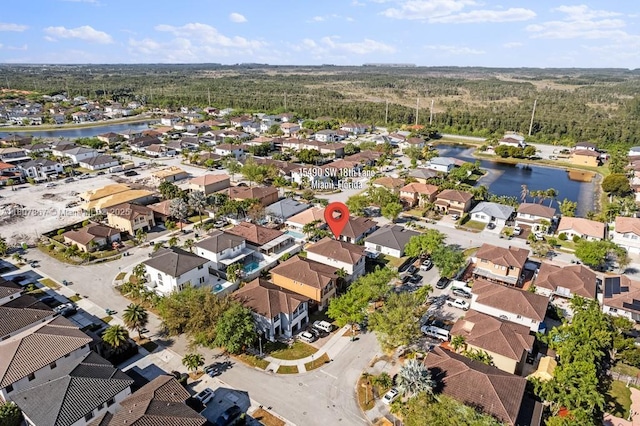 15490 SW 18th Ln, Miami, FL 33185 - aerial view of property and surrounding area featuring a nearby body of water, nearby suburban area, and a heavily wooded area