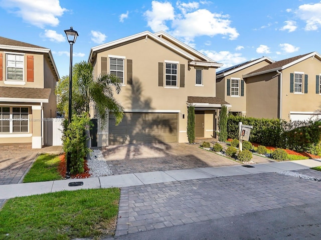 501 NE 6th Ct, Florida City, FL 33034 - traditional-style home with stucco siding, an attached garage, and decorative driveway
