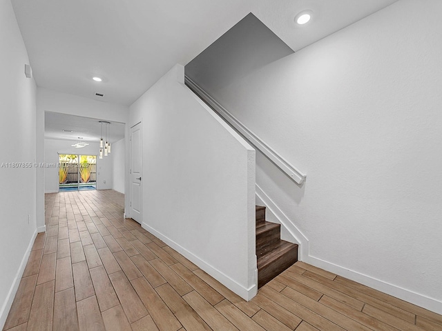 501 NE 6th Ct, Florida City, FL 33034 - stairs featuring wood finished floors, baseboards, and recessed lighting