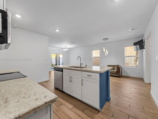 501 NE 6th Ct, Florida City, FL 33034 - kitchen featuring a sink, stainless steel dishwasher, wood tiled floors, plenty of natural light, and recessed lighting