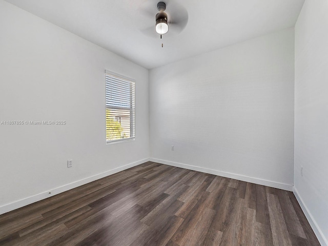 501 NE 6th Ct, Florida City, FL 33034 - empty room with dark wood-style flooring, a ceiling fan, and baseboards