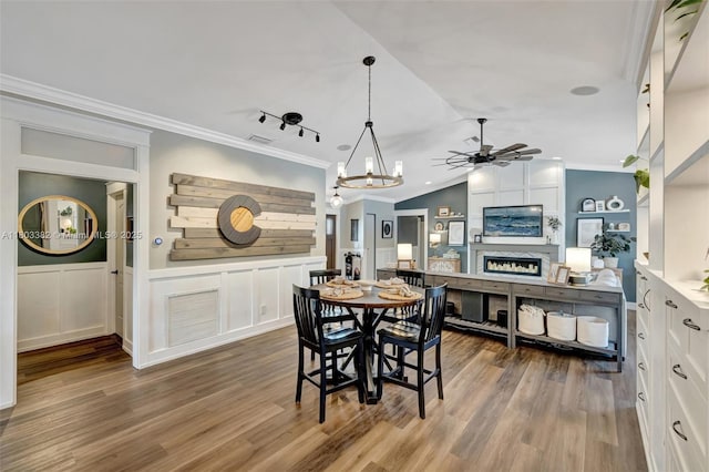7850 NW 53rd Ct, Lauderhill, FL 33351 - dining area featuring ceiling fan, wood finished floors, crown molding, vaulted ceiling, and wainscoting