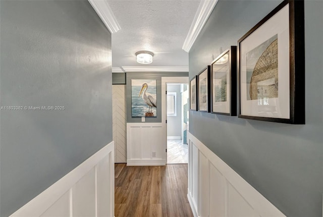 7850 NW 53rd Ct, Lauderhill, FL 33351 - hall featuring a textured ceiling, ornamental molding, and light wood-style flooring