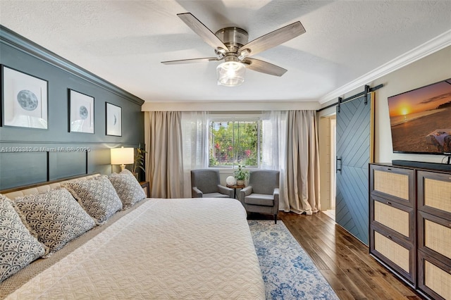 7850 NW 53rd Ct, Lauderhill, FL 33351 - bedroom with crown molding, a barn door, a textured ceiling, wood finished floors, and ceiling fan