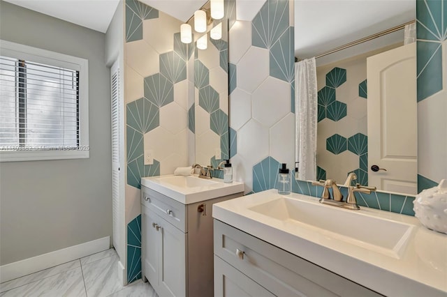 7850 NW 53rd Ct, Lauderhill, FL 33351 - bathroom with two vanities, tile walls, marble look tile flooring, and baseboards
