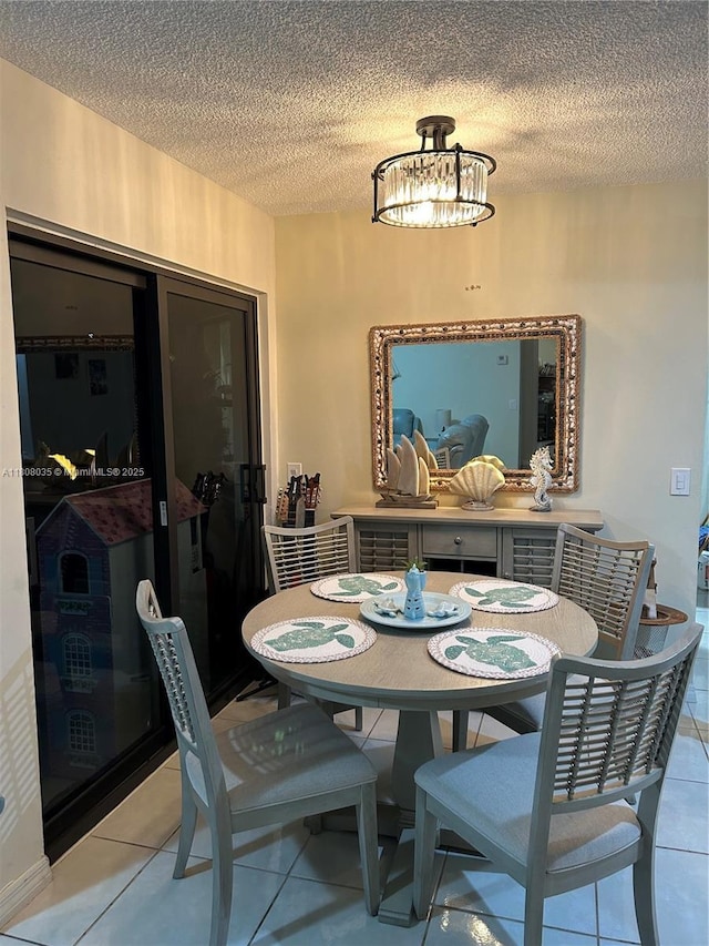 15210 SW 48th Ter Unit H-83, Miami, FL 33185 - dining space featuring a chandelier, a textured ceiling, and light tile patterned floors