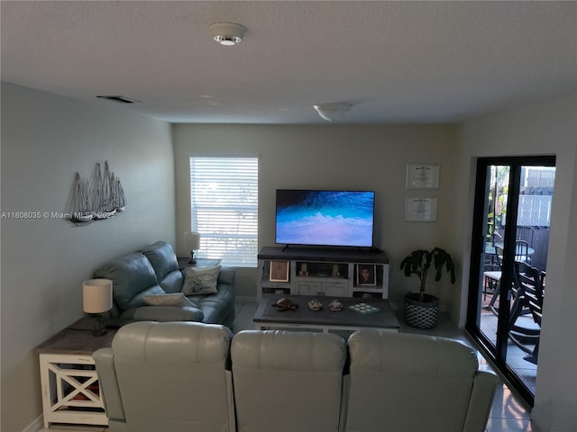 15210 SW 48th Ter Unit H-83, Miami, FL 33185 - living room with a textured ceiling and baseboards