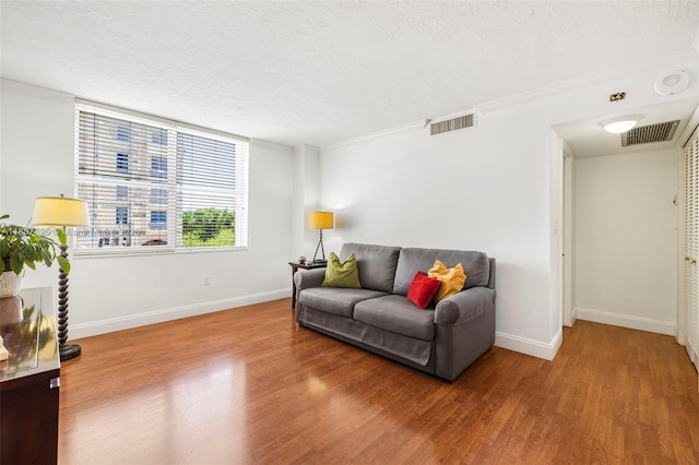 625 Biltmore Way Unit 301, Coral Gables, FL 33134 - living area with wood finished floors, baseboards, and a textured ceiling