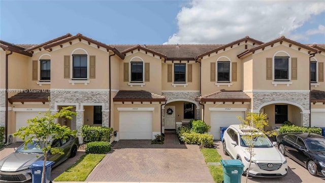 10260 SW 228th Ter Unit 10260, Miami, FL 33190 - view of property with a garage, stucco siding, driveway, and a tiled roof