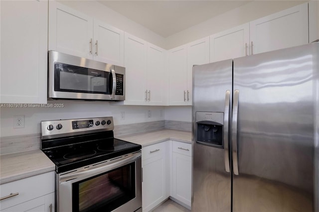 10260 SW 228th Ter Unit 10260, Miami, FL 33190 - kitchen featuring stainless steel appliances, light countertops, and white cabinetry