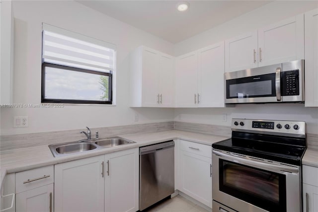 10260 SW 228th Ter Unit 10260, Miami, FL 33190 - kitchen featuring stainless steel appliances, a sink, white cabinetry, light countertops, and recessed lighting