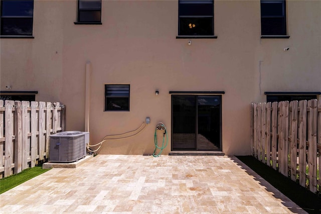 10260 SW 228th Ter Unit 10260, Miami, FL 33190 - rear view of house with stucco siding, central AC, and a patio