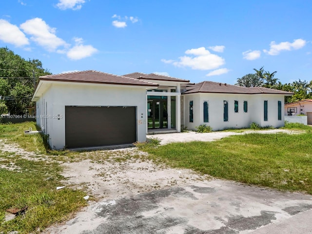 8275 SW 93rd St, Miami, FL 33156 - prairie-style home featuring driveway, an attached garage, stucco siding, a tile roof, and a front yard