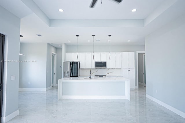 3806 E 18th St, Lehigh Acres, FL 33972 - kitchen with appliances with stainless steel finishes, baseboards, recessed lighting, a kitchen island with sink, and white cabinets