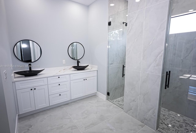 3806 E 18th St, Lehigh Acres, FL 33972 - bathroom featuring marble finish floors, double vanity, a marble finish shower, and baseboards