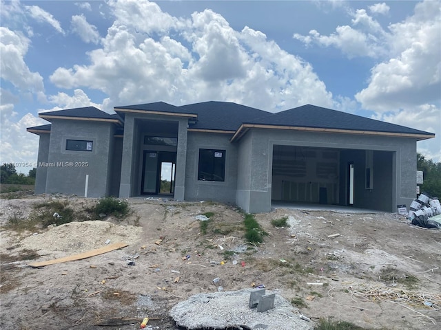 3806 E 18th St, Lehigh Acres, FL 33972 - view of front of home featuring stucco siding, an attached garage, and dirt driveway