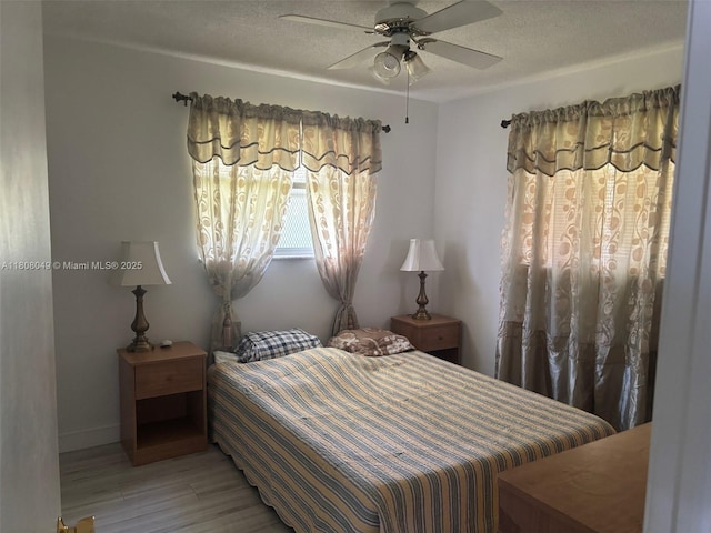 2427 Garland Cir Unit 195, Hollywood, FL 33021 - bedroom featuring light wood finished floors, a textured ceiling, and a ceiling fan