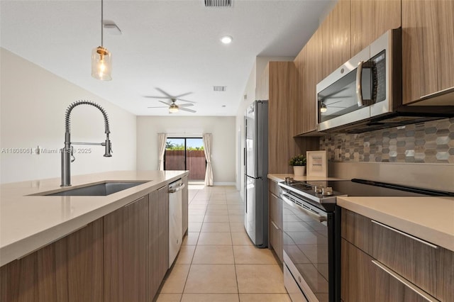 7825 NW 104th Ave Unit 4, Doral, FL 33178 - kitchen featuring appliances with stainless steel finishes, a sink, ceiling fan, light countertops, and decorative backsplash