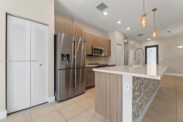 7825 NW 104th Ave Unit 4, Doral, FL 33178 - kitchen featuring appliances with stainless steel finishes, a sink, light tile patterned floors, light countertops, and modern cabinets