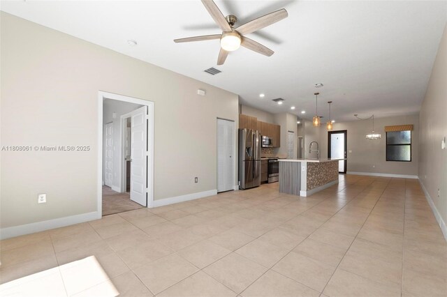 7825 NW 104th Ave Unit 4, Doral, FL 33178 - unfurnished living room featuring a ceiling fan, a sink, light tile patterned flooring, and baseboards