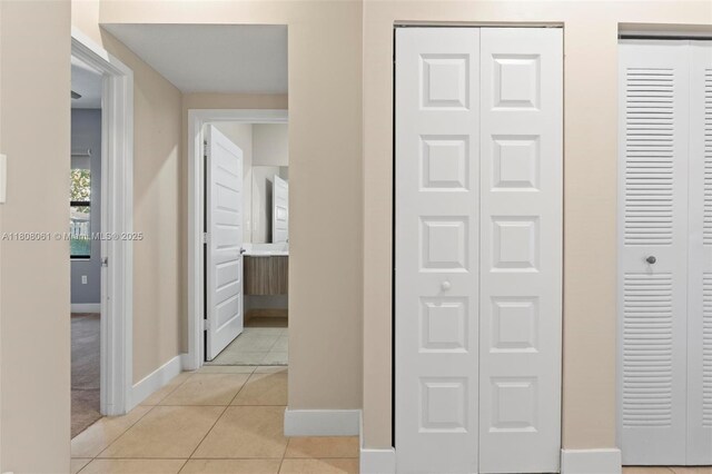 7825 NW 104th Ave Unit 4, Doral, FL 33178 - corridor with baseboards and light tile patterned floors