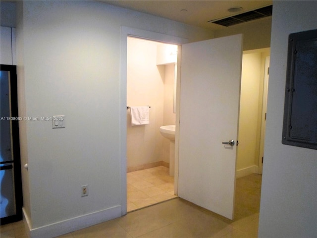 1050 Brickell Ave Unit 202, Miami, FL 33131 - unfurnished bedroom featuring electric panel, baseboards, light tile patterned floors, and ensuite bath