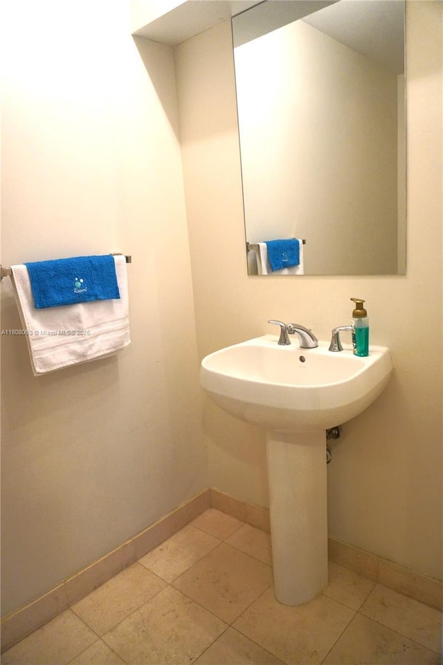 1050 Brickell Ave Unit 202, Miami, FL 33131 - bathroom with baseboards, tile patterned flooring, and a sink