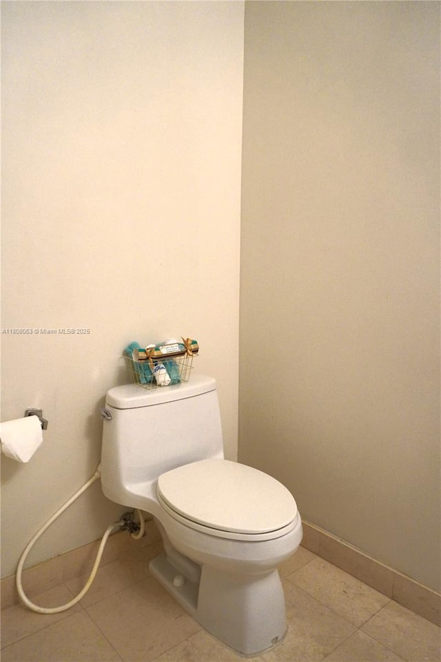 1050 Brickell Ave Unit 202, Miami, FL 33131 - bathroom featuring toilet, tile patterned floors, and baseboards