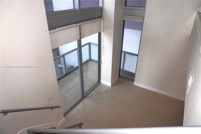 1050 Brickell Ave Unit 202, Miami, FL 33131 - stairway featuring plenty of natural light and baseboards