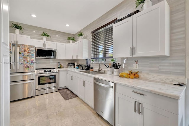 1317 Majesty Ter, Weston, FL 33327 - kitchen with stainless steel appliances, a sink, decorative backsplash, white cabinets, and recessed lighting
