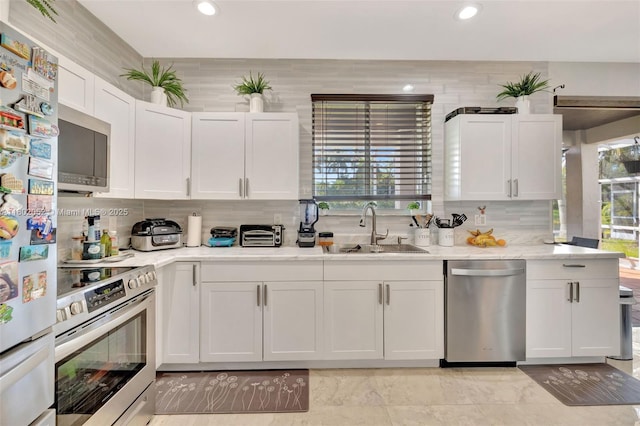 1317 Majesty Ter, Weston, FL 33327 - kitchen with stainless steel appliances, a sink, plenty of natural light, backsplash, and recessed lighting