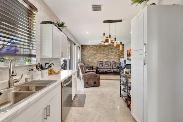 1317 Majesty Ter, Weston, FL 33327 - kitchen with a sink, dishwasher, plenty of natural light, and white cabinetry
