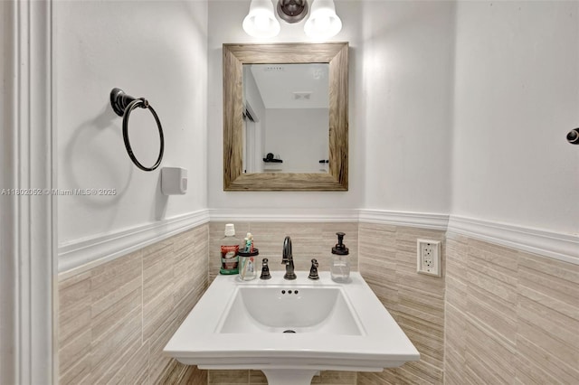 1317 Majesty Ter, Weston, FL 33327 - bathroom featuring tile walls, a sink, and a wainscoted wall