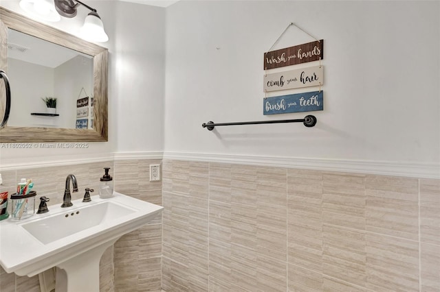 1317 Majesty Ter, Weston, FL 33327 - bathroom with a sink, wainscoting, and tile walls