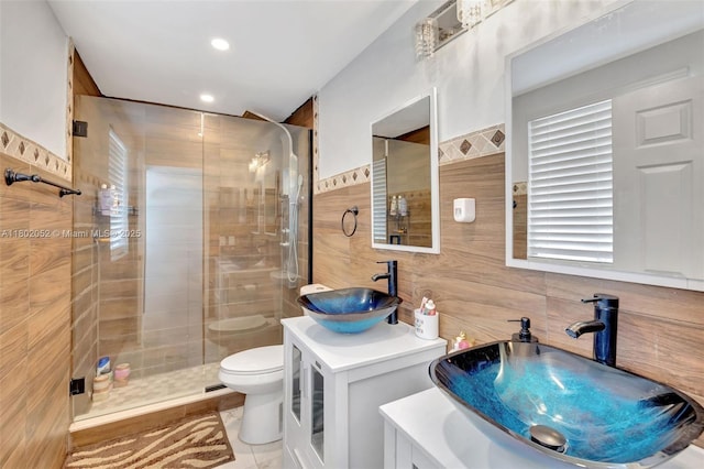 1317 Majesty Ter, Weston, FL 33327 - full bath featuring tile walls, a stall shower, toilet, two vanities, and recessed lighting