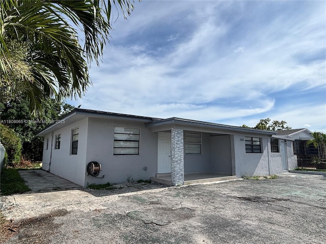 650 E 55th St, Hialeah, FL 33013 - view of front of property with stucco siding and asphalt driveway