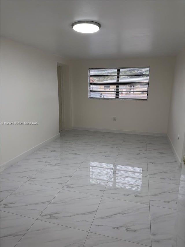 650 E 55th St, Hialeah, FL 33013 - unfurnished room featuring light marble finish floors and baseboards