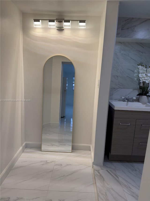 650 E 55th St, Hialeah, FL 33013 - hallway with light marble finish floors and arched walkways