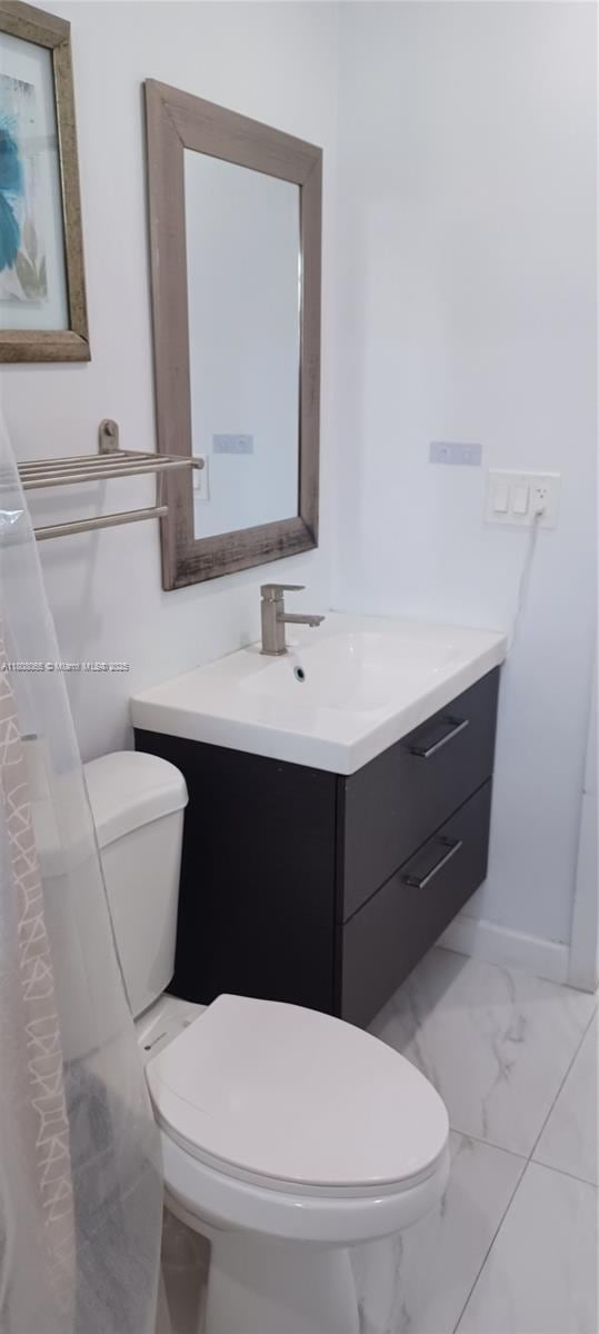 650 E 55th St, Hialeah, FL 33013 - bathroom featuring vanity and marble finish flooring