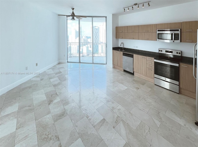 350 S Miami Ave Unit 3013, Miami, FL 33130 - kitchen featuring stainless steel appliances, a wall of windows, dark countertops, ceiling fan, and modern cabinets