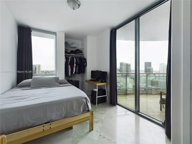 350 S Miami Ave Unit 3013, Miami, FL 33130 - bedroom featuring multiple windows, floor to ceiling windows, access to exterior, and light tile patterned floors
