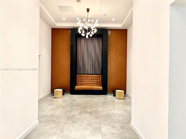350 S Miami Ave Unit 3013, Miami, FL 33130 - corridor featuring a tray ceiling, a chandelier, and an accent wall