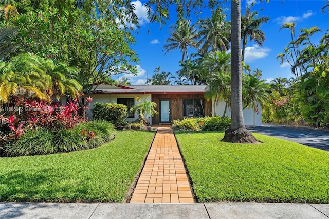 9155 SW 179th St, Palmetto Bay, FL 33157 - view of front of home featuring a front lawn, asphalt driveway, and an attached garage