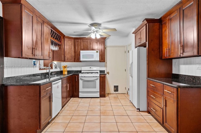9155 SW 179th St, Palmetto Bay, FL 33157 - kitchen with white appliances, a ceiling fan, a sink, light tile patterned floors, and dark stone counters