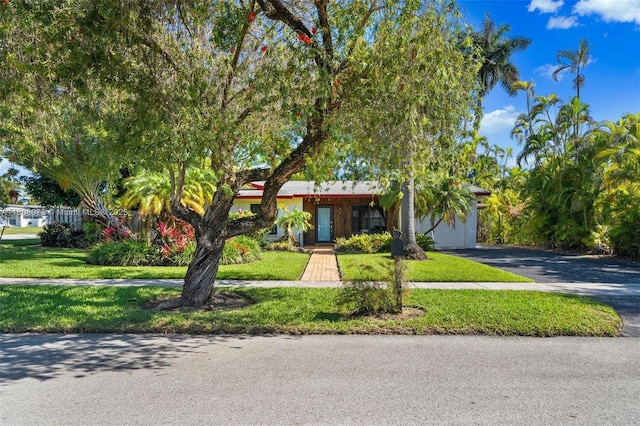 9155 SW 179th St, Palmetto Bay, FL 33157 - view of front of house featuring asphalt driveway, a front yard, and a garage