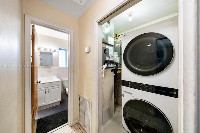 6121 SW 40th Ct, Miramar, FL 33023 - laundry room with stacked washer / dryer and light tile patterned floors