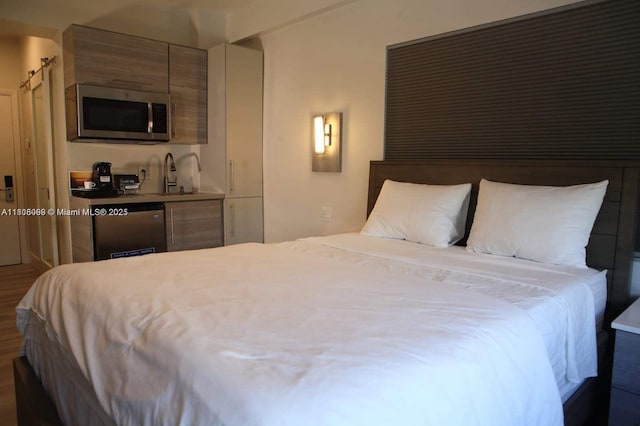 763 Pennsylvania Ave Unit 101, Miami Beach, FL 33139 - bedroom with bar with sink and wood finished floors